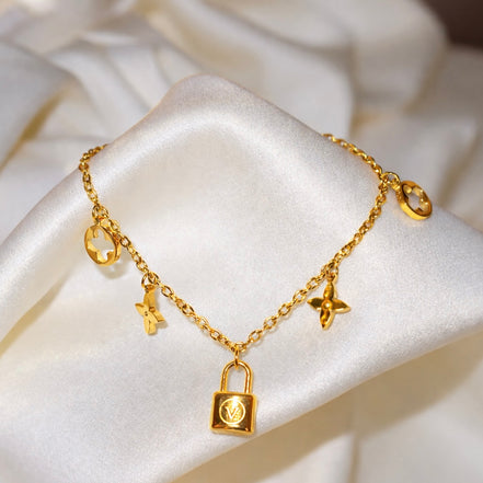 Bracelet doré en acier inoxydable cadenas et trèfles | Naomi